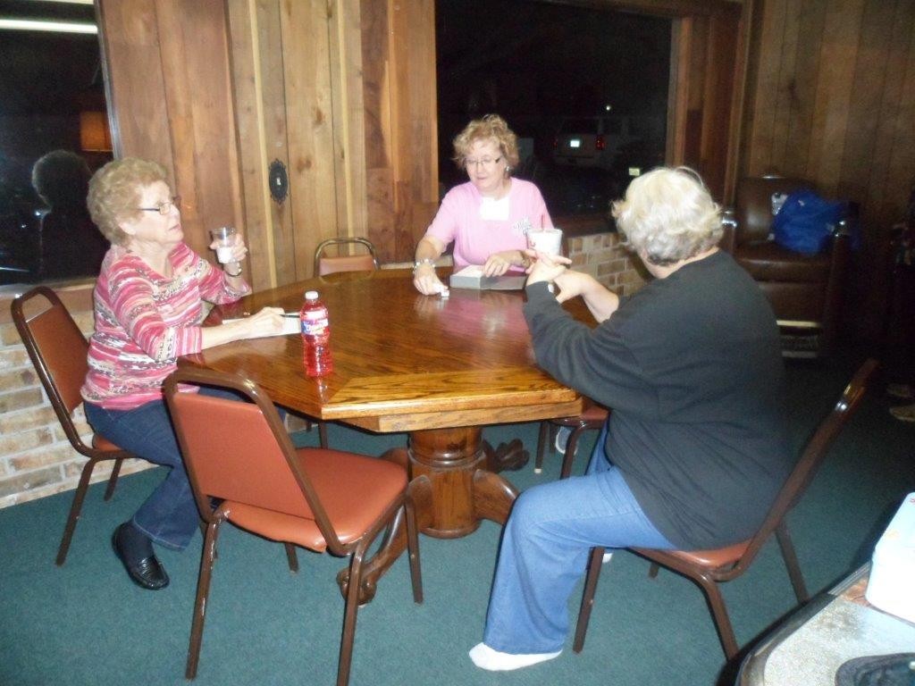 Annie Mae, Cheryl, and an unidentified LWML Zone member playing games at the LWML retreat held at Caney Creek Orchard in Wharton on January 30 and 31.