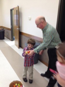Dylan gets help from Jeff Shofner during our indoor Easter Egg Hunt.