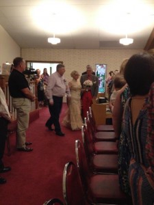 Pictured is Carole Blazek being escorted to the altar by her brother, Butch Blazek.