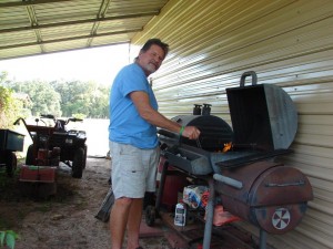 Mark Woolley firing up the grill in preparing to make hamburgers and hot dogs for the Rally Day crowd.