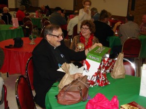 Pastor Ray and Peggy shown enjoying their gifts after the Christmas Program, including a Christmas Snoopy which lights up. Pastor Ray is infamous for quoting Snoopy and Charlie Brown in his sermons.