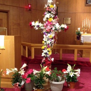 A picture of our beautiful Easter Cross (Cross of Glory),  designed by Sheila Johnson.  Note the location and symbolism of the red  flowers. 