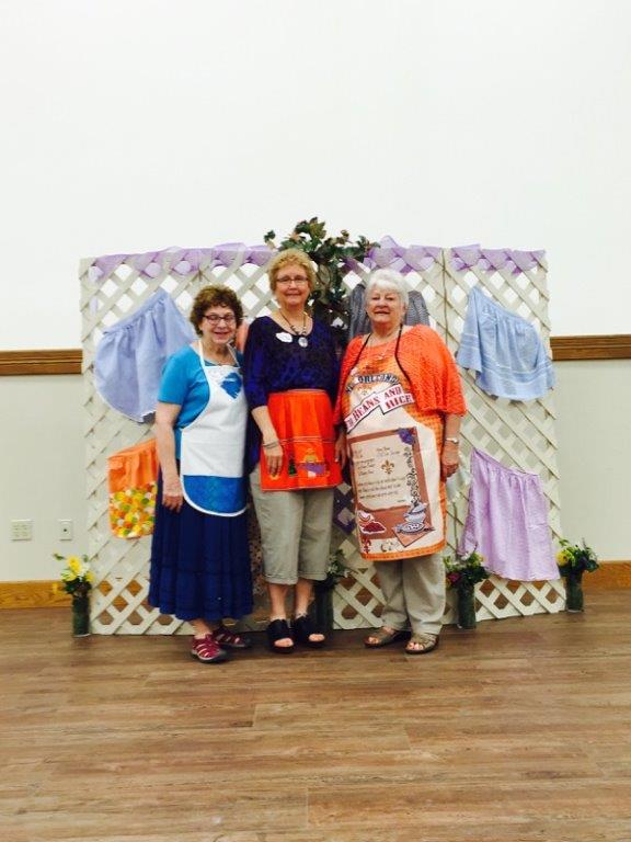 Peggy Spitzenberger, Cheryl Davis and Sheila Johnson are shown wearing "aprons of the Bible" at the LWML Zone Rally in Mission Valley