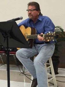 Mark Woolley playing guitar and leading the singing at our Friendship Sunday Cowboy style worship.