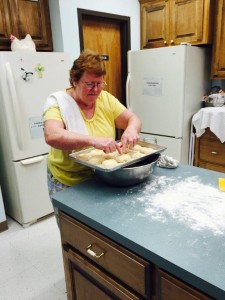 Maxine Cates busy preparing kolaches for the LWML Food Booth.